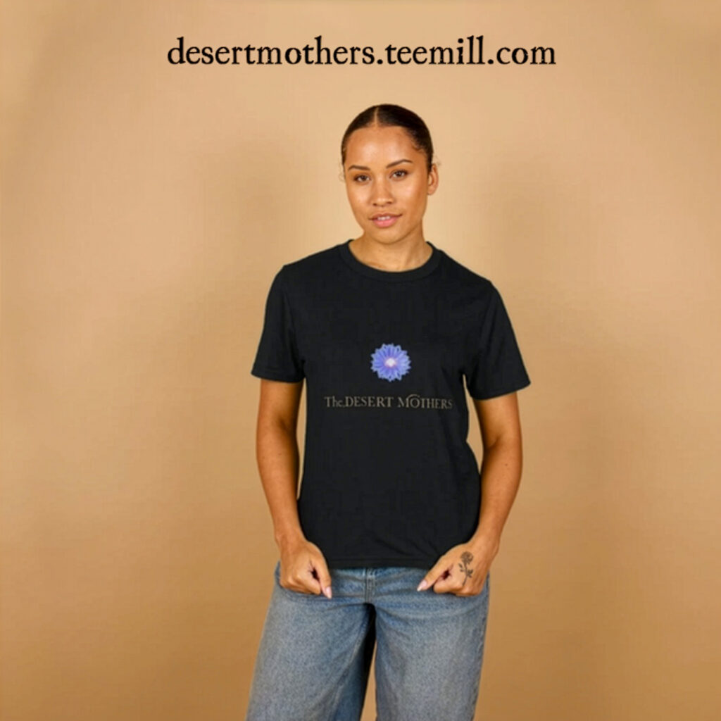 Young woman wearing a black Desert Mothers T-shirt, featuring the blue desert flower logo